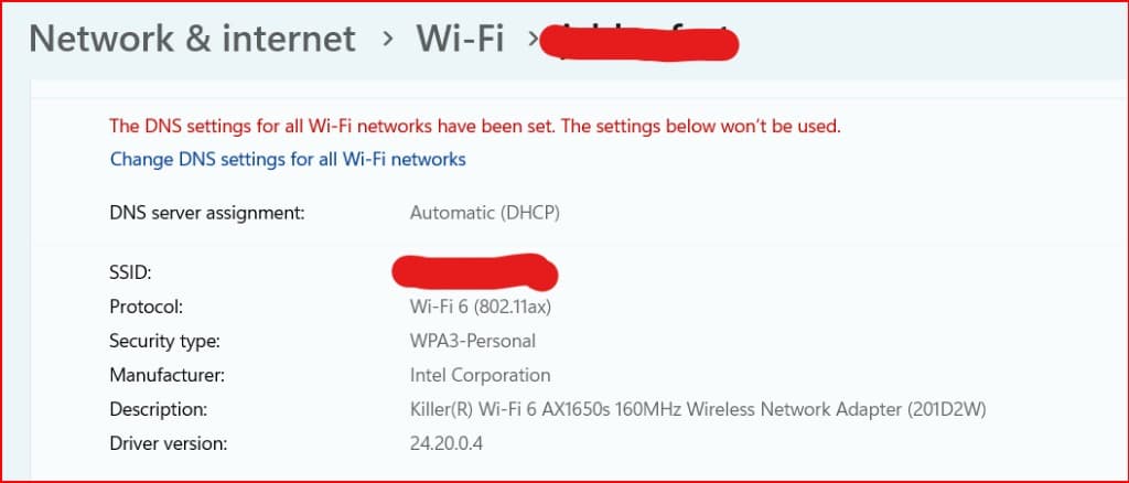 Windows 11 Wi-Fi properties with network name redacted. Protocol shows Wi-Fi 6 (802.11ax), security type WPA3-Personal, and an Intel Killer Wi-Fi 6 AX1650s adapter. SSID is covered with a red redaction mark.
